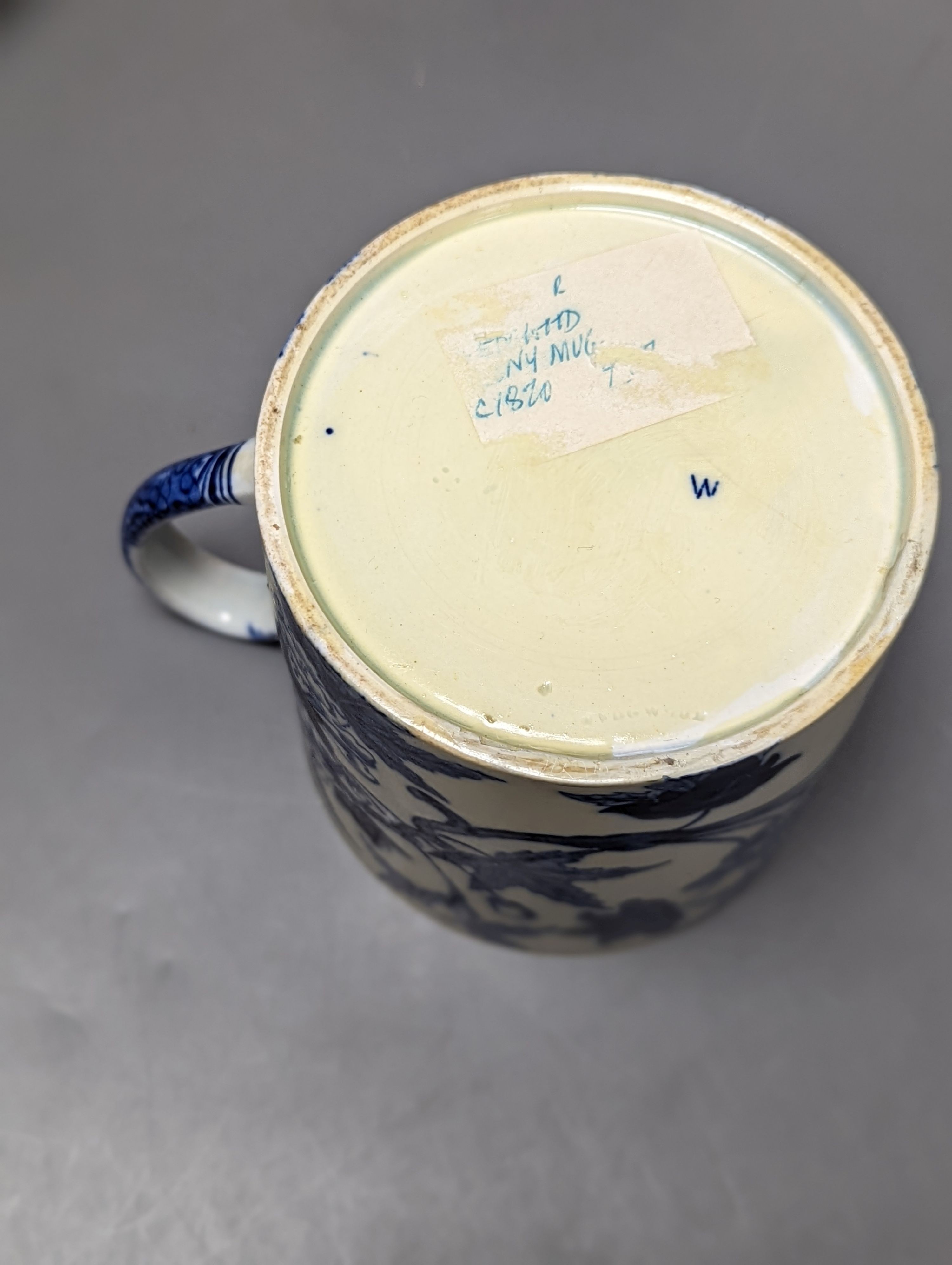 Four items of early 19th century blue and white pearlware pottery, an 18th century Delft blue and white vase and a 19th century toothbrush holder, Delft vase 22 cms high.